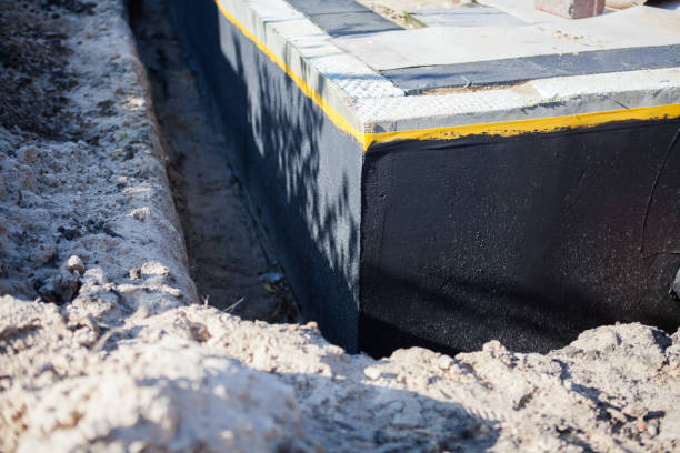 Professional Basement Waterproofing technician working in Woodburn, OR